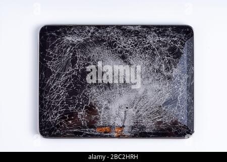 Tablet isolated on white background. The glass of the touchscreen is broken. Stock Photo
