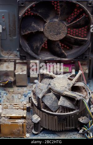 View inside the personal computer. Lot of dust on the motherboard, processor and cooling radiator. Stock Photo