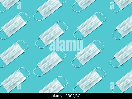 Pattern of Medical mask on blue background, flat lay top view. Protection against virus, coronavirus, flu, colds, diseases. Traditional medical tool, concept of health. Allergy season Stock Photo