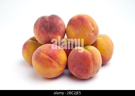 Several peaches isolated on white background. Stock Photo