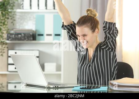 Excited self employed checking laptop content at homeoffice Stock Photo