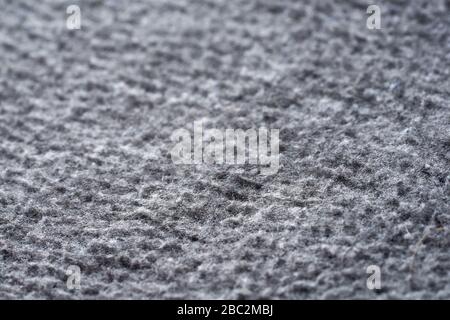 Closeup gray texture of woolen knitted fabric. Pattern of gray crumpled fabric. High-quality selective focus macro photography. Stock Photo