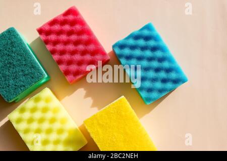 Multi-colored foam rubber sponge for cleaning and washing dishes on a white background. top view, pattern. flat lay.Sponges for washing and cleaning Stock Photo