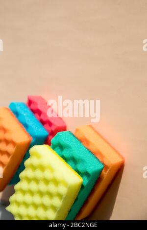 Multi-colored foam rubber sponge for cleaning and washing dishes on a pastel background. top view, pattern. flat lay.Sponges for washing and cleaning Stock Photo