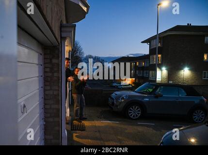 Brighton UK 2nd April 2020 - Residents of Queens Park in Brighton applauding NHS and key workers tonight as the country thanks them for their efforts in the battle against coronavirus COVID-19   : Credit Simon Dack / Alamy Live News Stock Photo