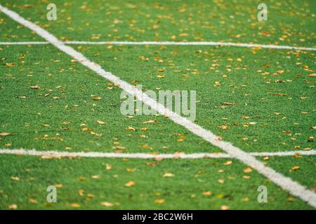 Artificial grass, sports field cover with marking. Artificial turf used in different sports: football, soccer, rugby, tennis, baseball, american footb Stock Photo