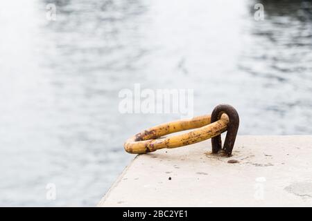 Iron ring for mooring boats on the pier. Stock Photo