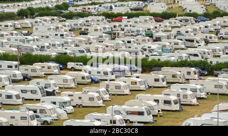 BUILTH WELLS, POWYS, WALES - JULY 2018: Rows of caravans parked in fields by people outside the Royal Welsh Showground during show time