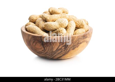 Tasty unpeeled peanuts in bowl isolated on white background. Stock Photo