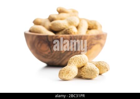 Tasty unpeeled peanuts isolated on white background. Stock Photo