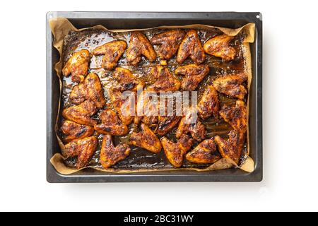 Grilled chicken wings in barbecue sauce in baking tray isolated on white background. Stock Photo