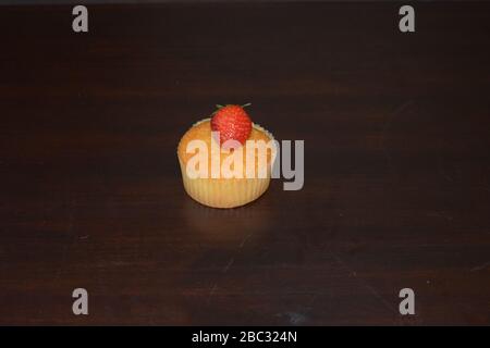 Strawberry cupcake with strawberry on the top, space to add text Stock Photo