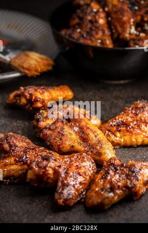 Grilled chicken wings on black rustical table. Stock Photo