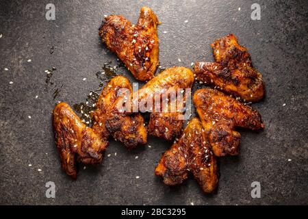 Grilled chicken wings on black rustical table. Stock Photo