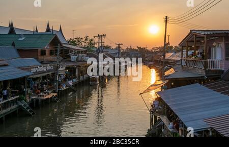 Amphawa Floating Market, Thailand at sunset, river view with wooden houses and boats Stock Photo
