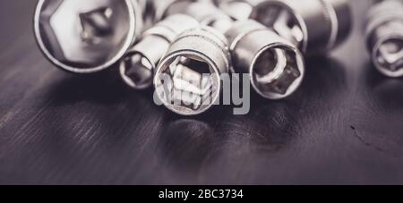 Socket wrenches isolated on wooden background Stock Photo