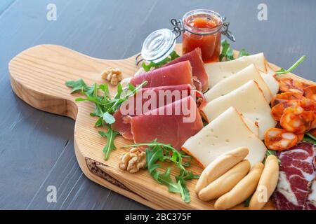 Sliced meat appetizer, meat dessert before lunch. Hamon sausages smoked products ham cheese and olives. Mediterranean food Stock Photo