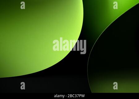 Abstract -  sheets of rolled green paper on a black background. Simple, isolated object with text space perfect for illustrating various concepts. Stock Photo
