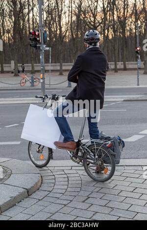 man on folding bike is waiting at the traffic light Stock Photo