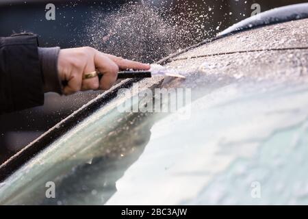 ice scraper on the windshield of a car Stock Photo