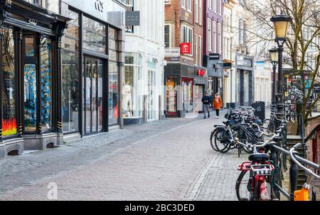 View of the Utrecht city center with closed shops at the Oudegracht (Old Canal). Streets are quiet due to the COVID-19 pandemic. The Netherlands. Stock Photo