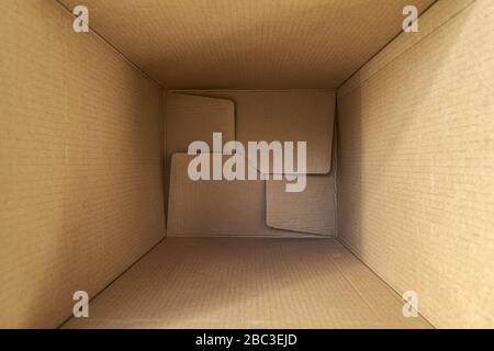 Opened empty cardboard box, with copy space. Delivery concept. Top view. Stock Photo