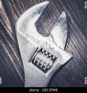 Forged steel wrench on wooden floor Stock Photo