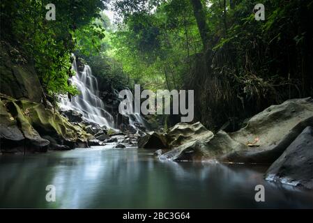 Kanto Lampo curtain waterfall and river in a forest canyon, long exposure photo near Ubud, Bali, Indonesia Stock Photo