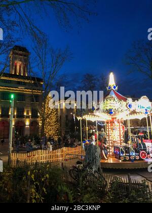 Montreuil, France, City Hall Building Lit up at Night with Merry-go-Round, Roundabout RIde on Town Square, suburban street night Stock Photo
