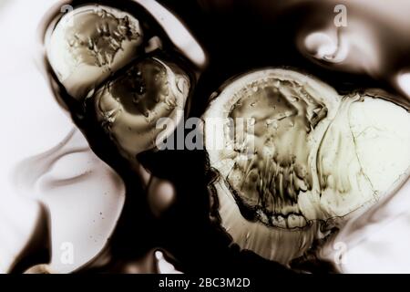 Messy paint background stains. Ink drops close up splatter liquid stain. Black ink coffee stain macro view. Stock Photo