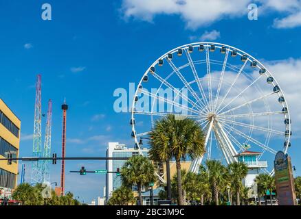 Ferris wheel in amusement park on Myrtle Beach Boardwalk along north ocean blvd in Myrtle Beach, South Carolina. Stock Photo