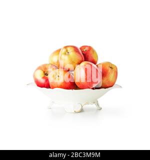 Fresh ripe red apples in bowl isolated on white background clipping path included. Apple fruits creative composition. Healthy eating and dieting conce Stock Photo