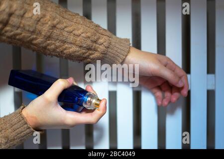 Hand putting perfume on her wrist. Perfume concept. Stock Photo