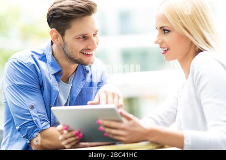 Couple using digital tablet at cafe Stock Photo