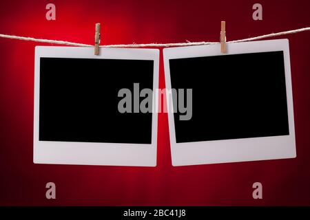 Two blank instant photo frames on red background Stock Photo