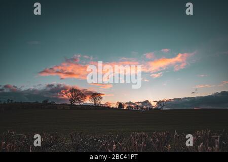 Colourful sunset clouds over farming fields of Shropshire in United Kingdom Stock Photo