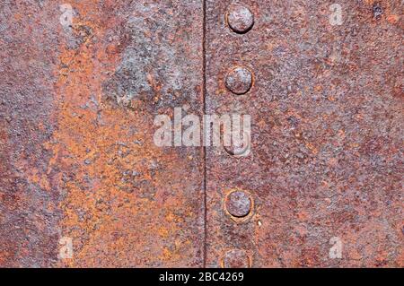 rusty riveted old corroded sheet iron background texture Stock Photo