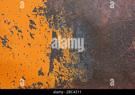peeled and scratched yellow painted old rusty metal background Stock Photo