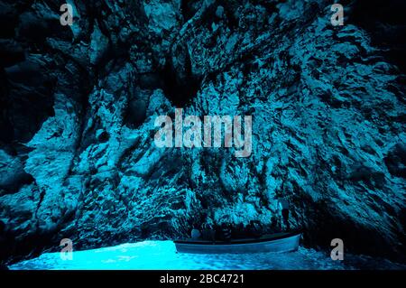 Bleu cave in Croatia, Croatian wonder, landmark. Tourist visiting the inside of the Blue cave, Bisevo island, light of blue color from water at midday Stock Photo