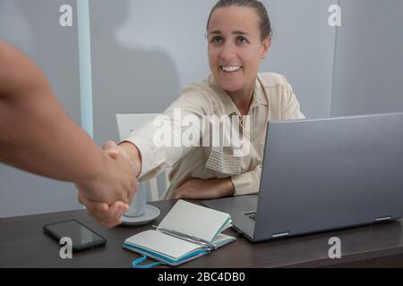 Female administrative working in the office and shaking hands Stock Photo