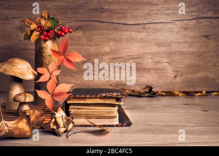 Autumn Thanksgiving arrangement with decorative wooden mushrooms. Fall leaves, apples, peppers and chestnuts. Autumn still life arrangement indoors, o Stock Photo