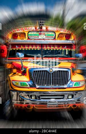 A brightly painted "chicken bus" in Antigua, Guatemala. Stock Photo