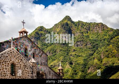 Church and Cerro del Rostro Maya (Hill of the Mayan Face)  in the village of San Juan on Lake Atitlan, Guatemala. Stock Photo