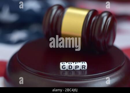 Justice mallet and GDPR acronym close up with US flag on background. General data protection regulation Stock Photo
