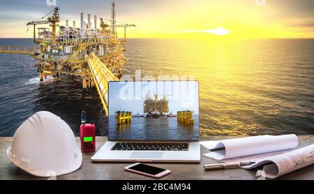 Management operation concept of technicians by using computer control working of offshore crude oil rigs in the Gulf of Thailand, oil and gas explorat Stock Photo