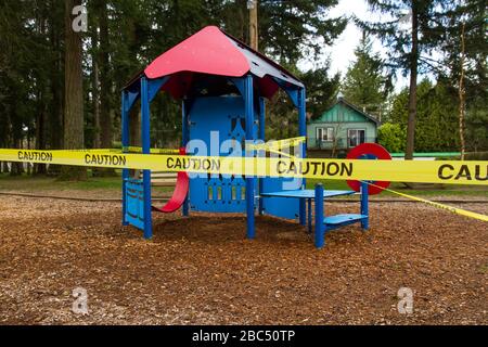 A childrens playhouse caution taped off at a playground Stock Photo