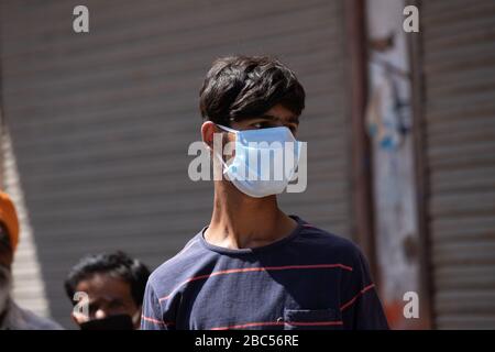 Ambala Haryana India, 02 April 2020. Indian young man wearing Mask at road helping poor Families with food and Daily life Essential Needs Stock Photo