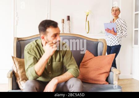 Low-spirited short-haired modern young man looking away Stock Photo