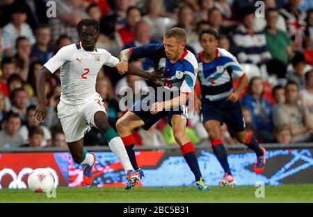 Great Britain's Craig Bellamy battles for possesion with Senegal's Saliou Ciss during the Great Britain v Senegal, Mens Football, First Round, Group A match at Old Trafford, Manchester. Stock Photo