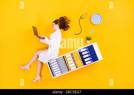 Top above high angle view full size profile side photo of woman doc sit shelf flat lay work computer search corona virus cure information isolated Stock Photo